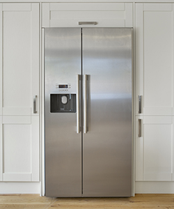 "a modern American fridge freezer set into a bank of cream coloured cupboards in a farmhouse-style kitchen. Made from brushed stainless steel, this is a high quality unit with ice cube dispenser.Looking for a Kitchen, Dining Room or dining related image Then please see my other images by clicking on the Lightbox link below..."